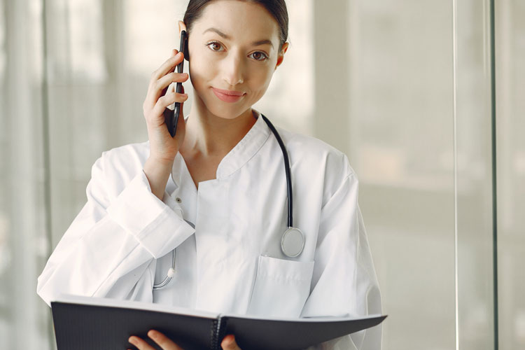 Doctor Is Taking to Someone While Smiling