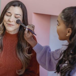 Woman Applying Flawless Foundation on Friend's Face