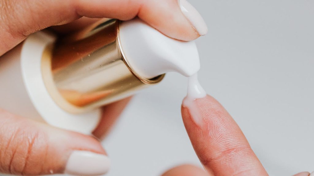 person holding white plastic bottle