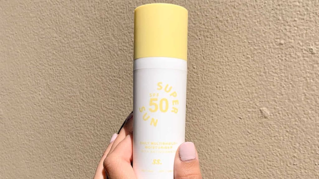 white and yellow sunscreen bottle