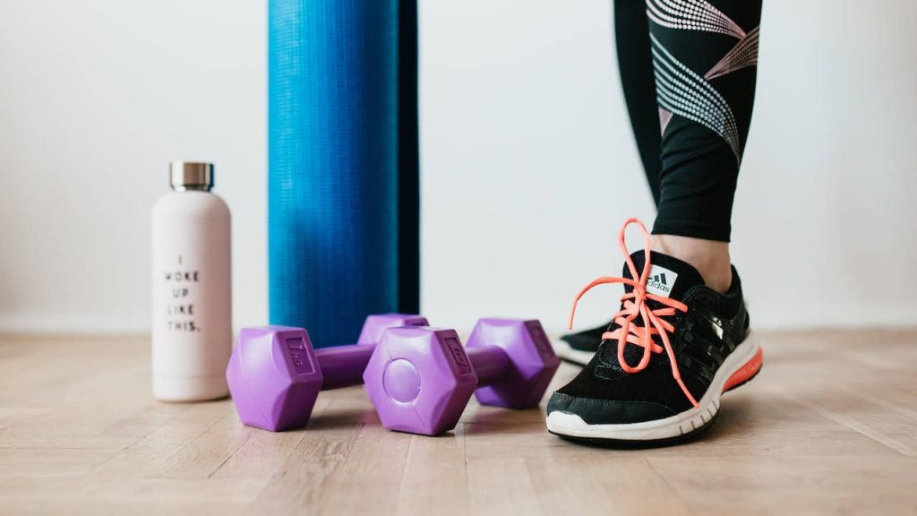 woman standing near sports accessories