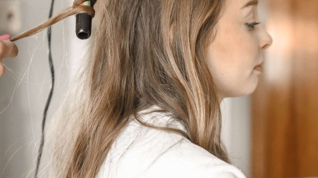 woman curling her hair