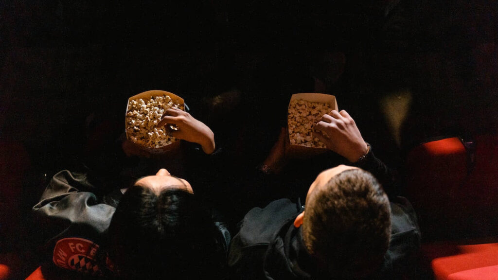 People Eating Popcorn at a Cinema