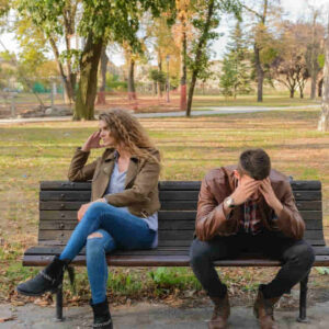 Woman And Man Sitting on Brown Wooden Bench