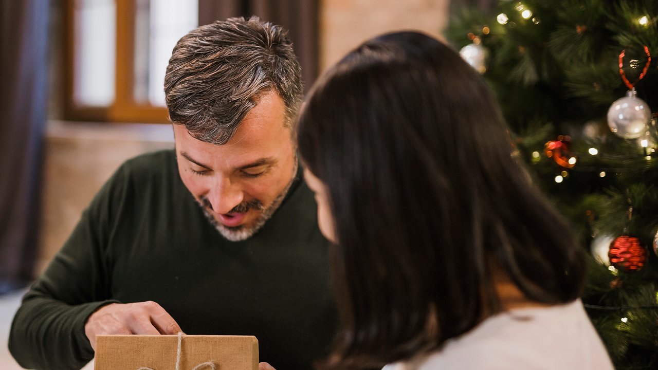  An elder man opening his gift