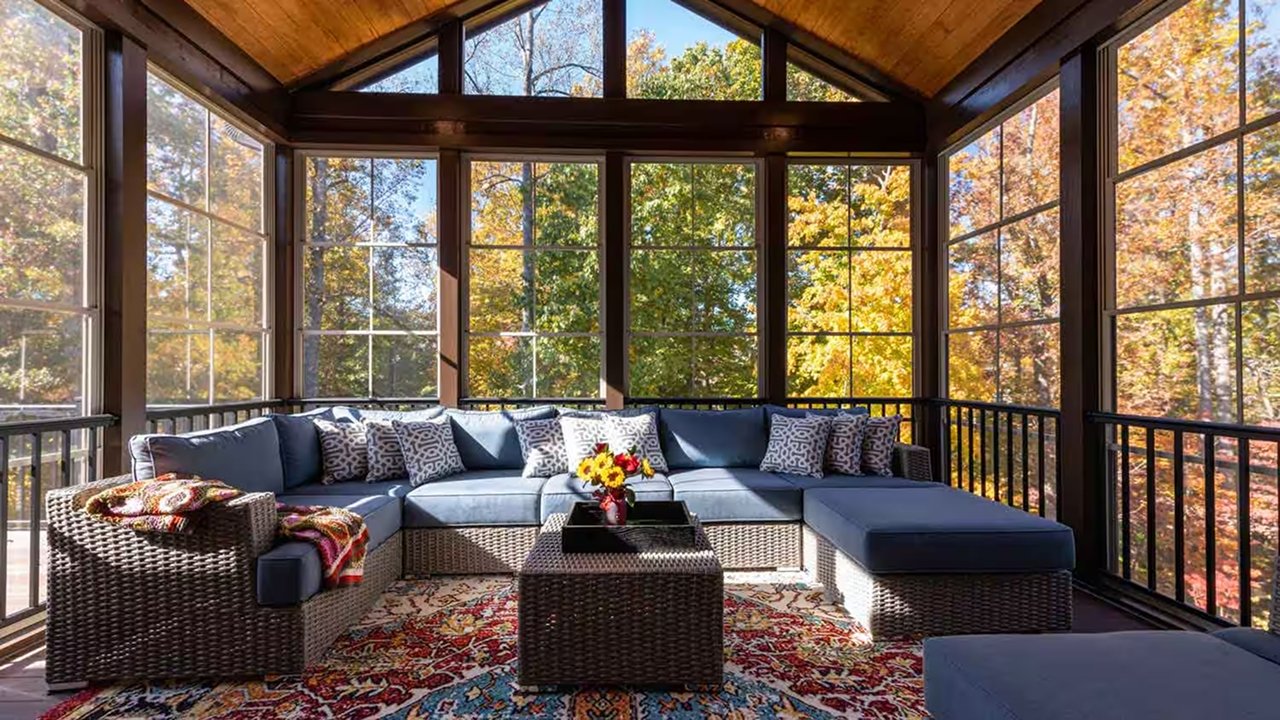 A cozy dark themed 4 season sunroom