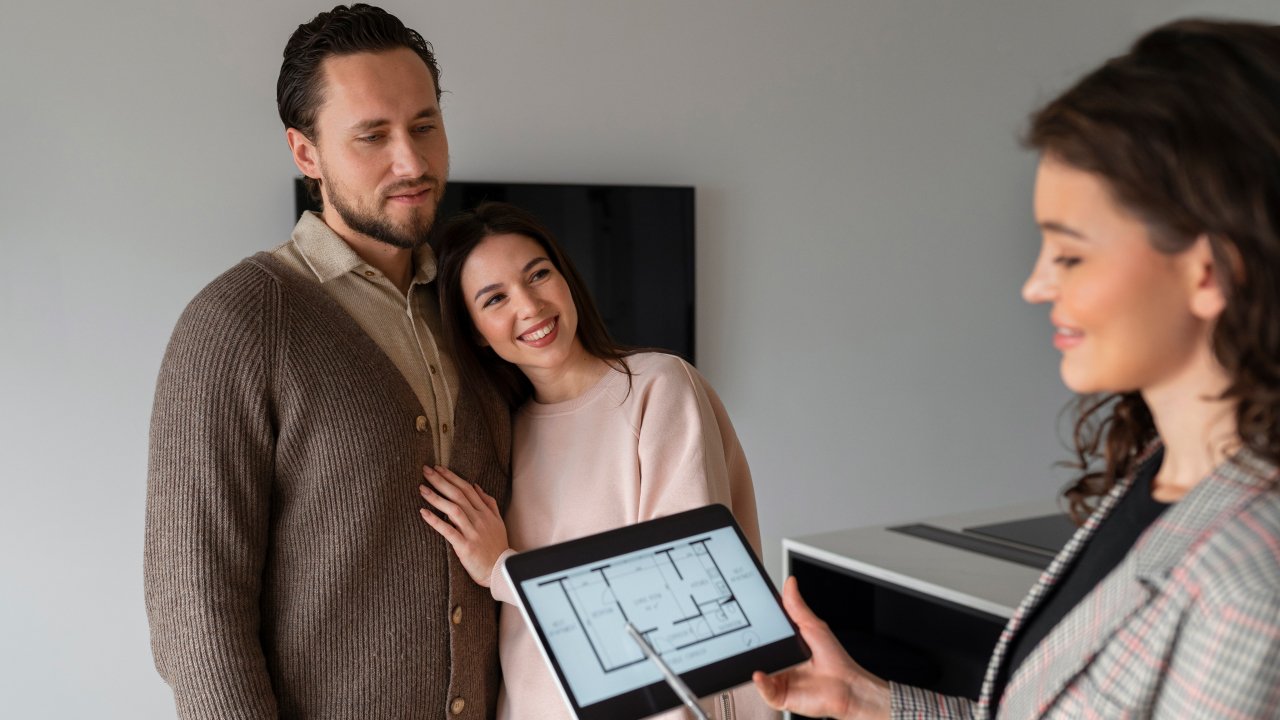 Side view of a real estate agent holding a tablet