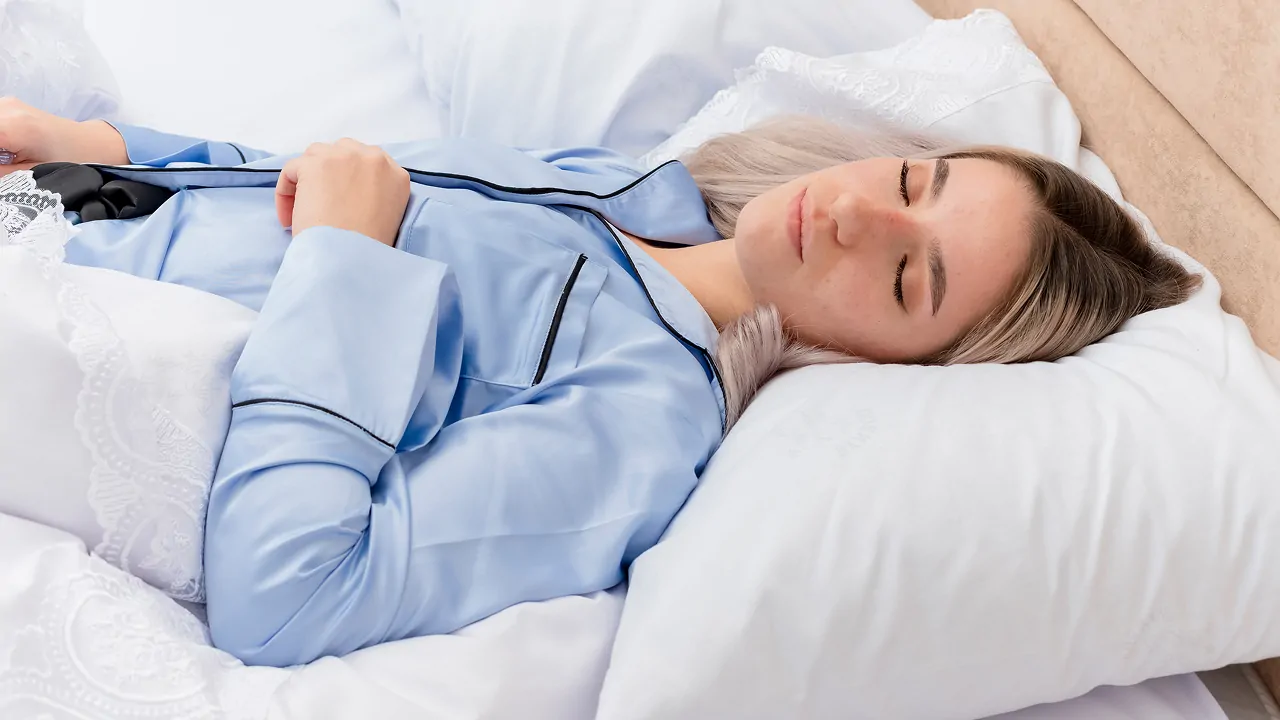 A girl sleeping peacefully on a bed