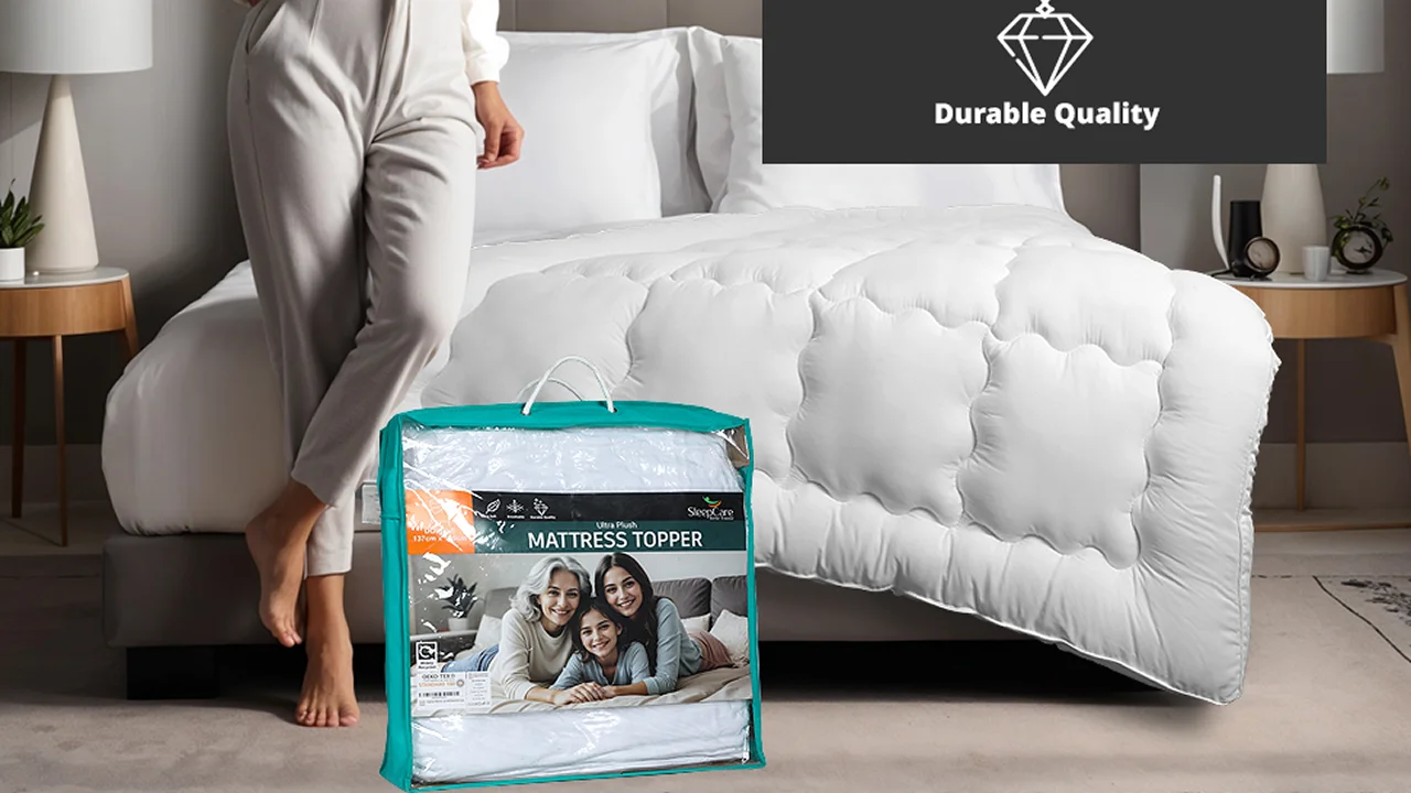 Sleepcare white quilted mattress topper on a bed